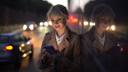 A businesswoman using smartphone to communicate with friends after working day