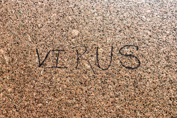 VIRUS inscription on a granite wall in Washington DC. Corona virus epidemic time, COVID-19 on stone