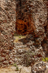 The ruins of the castle Castello Ruffo. Ruin of a Ghost Town in National Park Aspromonte with the Fiumara (river) of Amendolea, Calabria, Italy