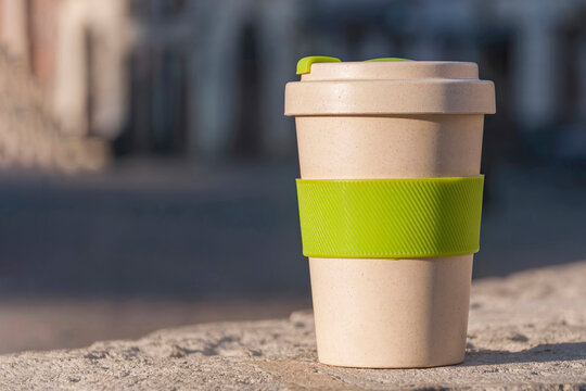 Eco cup on a background of buildings. The concept of ecology and lack of garbage