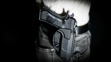 Man openly carrying a pistol on his belt. Open carry and second amendment concept.