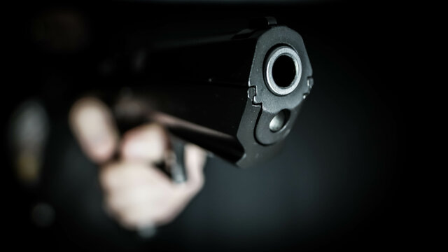 Man holding a pistol in a firing position. Personal defense concept