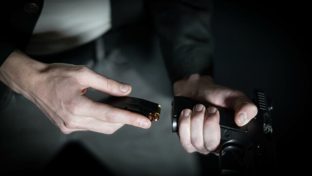 Man loading a 9mm pistol. Personal defense and concealed carry concept