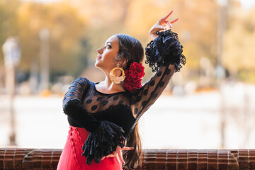 Hispanic woman dancing flamenco in traditional dress - obrazy, fototapety, plakaty