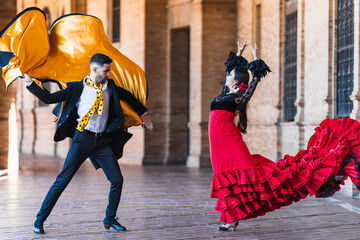 Fototapeta premium Man with a cloth dancing falmenco with a woman outdoors