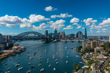 Fototapeta premium Low aerial view of Sydney City, Sydney Harbour and the Harbour Bridge on a sunny morning 