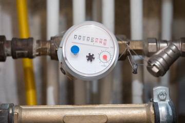 Close up shot water meter is blurred background pipes. Selective focus in on water meter - 477685340