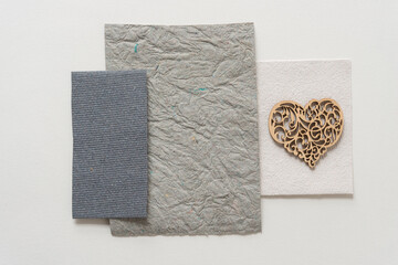 plain wooden heart shape on gray papers
