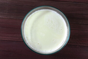 milk in glass bowl with bubble and cream top view
