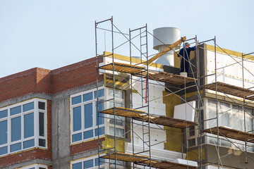 wall insulation of a multi-storey residential building using expanded polystyrene and mineral insulation plates