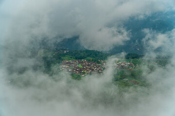 city on a hill covered with clouds from Telomoyo Mountain, Central Java, Indonesia