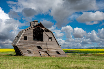 An abandoned barn ready to fall over on the prairies in Saskatchewan  © Nancy Anderson