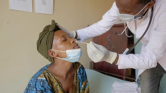 A Close Up Shot Of An African Woman Getting A Nasal Swab Test In Her Nose In A Rural Clinic In Africa.