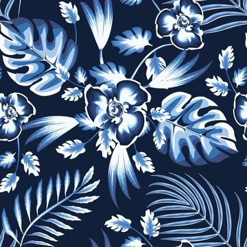 beautiful night summer tropical plant seamless pattern palm, fern and monstera leaves in blue monochromatic color on dark background with bright flowers drawing. fashionable texture. jungle print