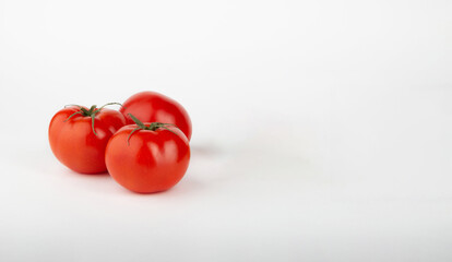 Ripe red tomatoes on a white background.Copy space.