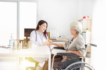 light and blur people, asian female doctor holding hand of old patient in mental health clinic, patient have a problem health , hand in hand, elderly healthcare promotion