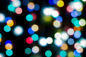 black abstract background with multicolored lights with bokeh in blur