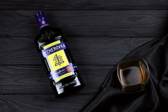 KHARKOV, UKRAINE - DECEMBER 3, 2020: Becherovka herbal liqueur bottle on dark black background. Elite alcohol