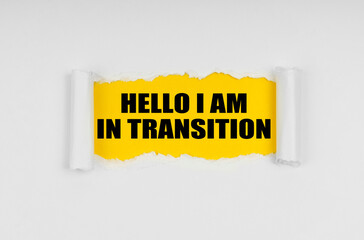 A window is made in the paper, where on a yellow background the inscription - Hello I Am In Transition