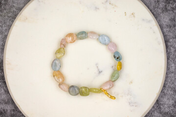 Bracelet made of natural stones on a dark background. Top view