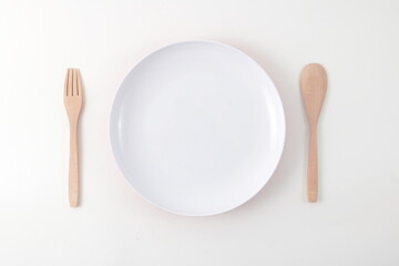 A simple set up of tableware that contain plate, spoon and fork
