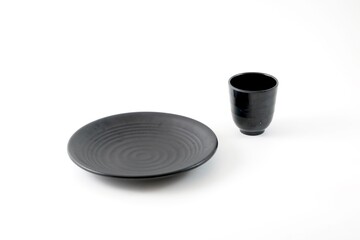 A black plate and a black glass isolated in a white background