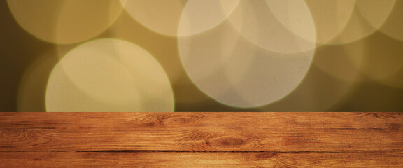 The background is an empty wooden board and a wall of blurred bokeh lights.