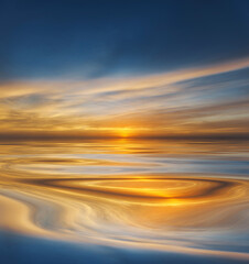 Sunset or sunrise reflected on smooth water