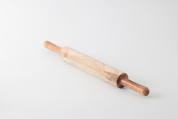 A small wooden rolling pin, usually used to flatten dough.