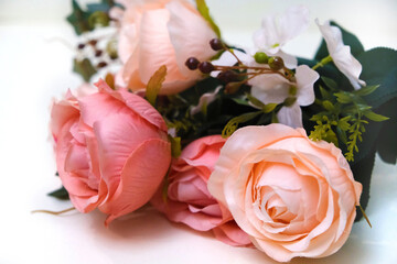 Bouquet of artificial pink roses on white background, home decor
