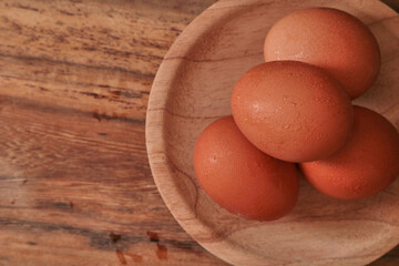 A few eggs on a wooden background.