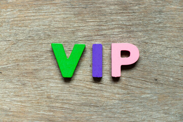 Color alphabet letter in word VIP (abbreviation of very important person) on wood background