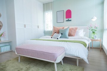 Stylish bedroom with modern green and yellow pillow and furniture. Interior design