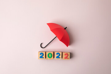 New Year 2022 with red umbrella on pink background