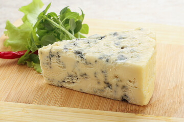 Blue cheese piece over board