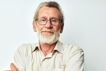 Portrait of happy senior man with a gray beard in a shirt and glasses isolated background