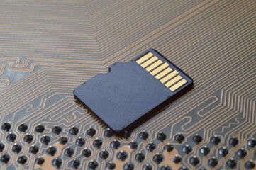the black micro sd card lies on the microcircuit. close-up.