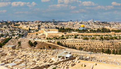 Fototapeta na wymiar Metropolitan Jerusalem panorama with Temple Mount and Old City with historic Jewish cemetery on slope of Mount of Olives in Israel
