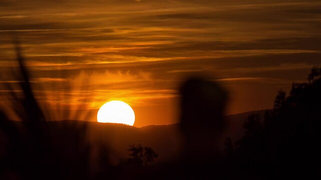 People admiring the sunset timelapse near Temple of Debod Park in Madrid.