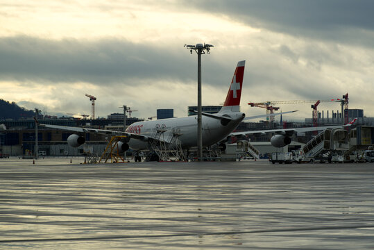 Zürich Airport with Swiss Airplanes on a cloudy and rainy winter day. Photo taken December 26th, 2021, Zurich, Switzerland.

