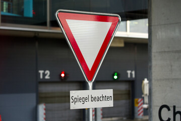 Traffic sign with text Spiegel beachten (German, translation is check mirror) at Dock Midfield at...