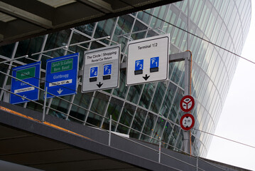 Traffic signs at Zürich Airport on a cloudy and rainy winter day. Photo taken December 26th, 2021, Zurich, Switzerland.
