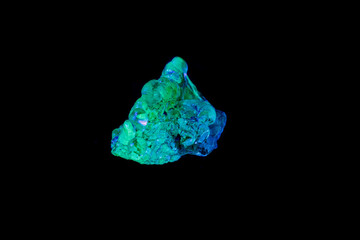 macro mineral stone opal under ultraviolet light on a black background
