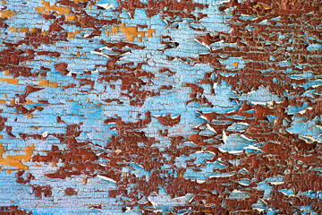 Old paint peeling off of a wooden plate