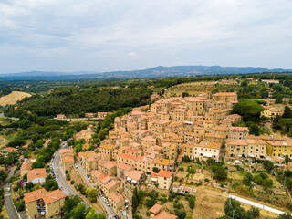 Fototapeta na wymiar Casale Marittimo, Tuscany, Pisa region, Medieval old town with cypress tress and crops hay, city on a hill top, landscape drone aerial panorama 
