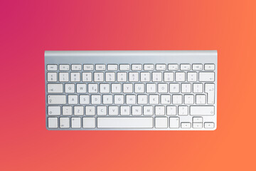 Computer keyboard on a colored background. Concept of typing, office work, remote work. Using your computer for work, play and online shopping.