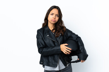 Obraz na płótnie Canvas Young woman holding a motorcycle helmet over isolated white background feeling upset
