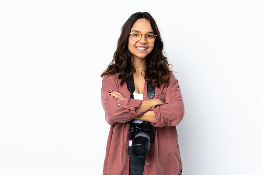 Young photographer woman over isolated white background keeping the arms crossed in frontal position
