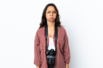 Young photographer woman over isolated white background with sad expression