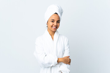 Young woman in bathrobe over isolated white background laughing